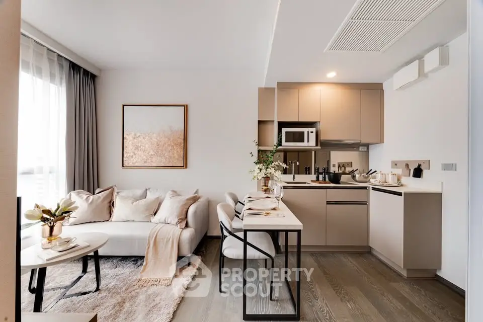 Modern open-plan living room and kitchen with stylish decor and natural light.