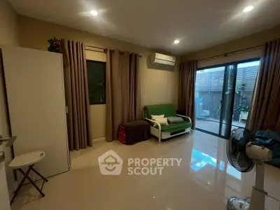 Spacious living room with modern decor and sliding glass doors to outdoor area.