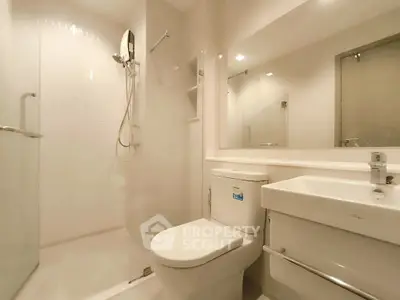 Modern bathroom with sleek fixtures and spacious shower area