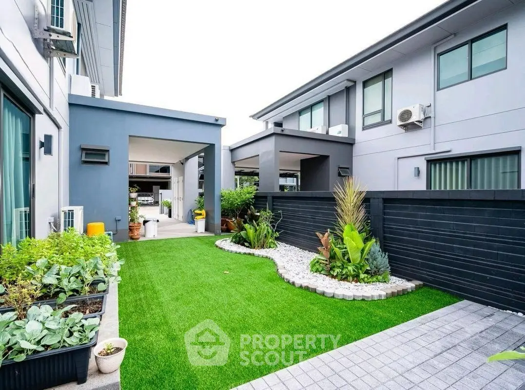 Modern townhouse with lush garden and sleek exterior design