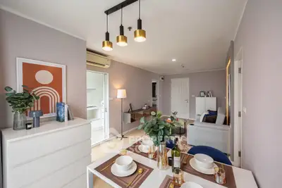 Modern living room with stylish decor and dining area in open layout apartment.