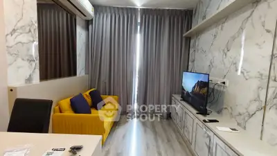 Modern living room with marble walls, yellow sofa, and flat-screen TV