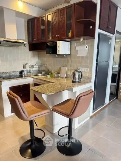 Charming kitchen with granite countertops and modern appliances, perfect for cozy dining and culinary adventures.
