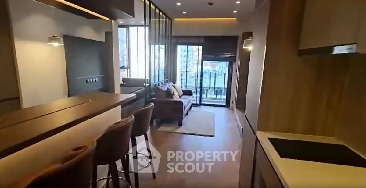 Modern open-plan living room with stylish kitchen and balcony view