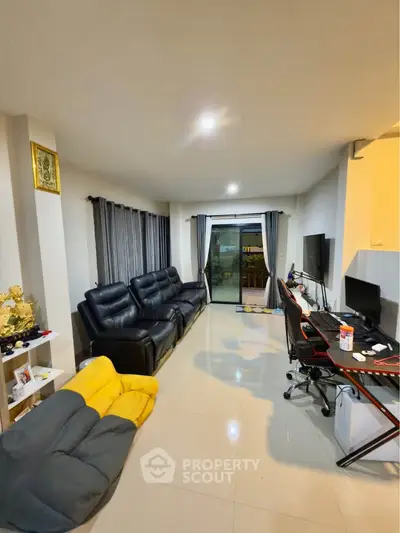 Spacious living room with modern furniture and large window view