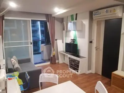 Modern living room with balcony access and stylish decor in urban apartment.