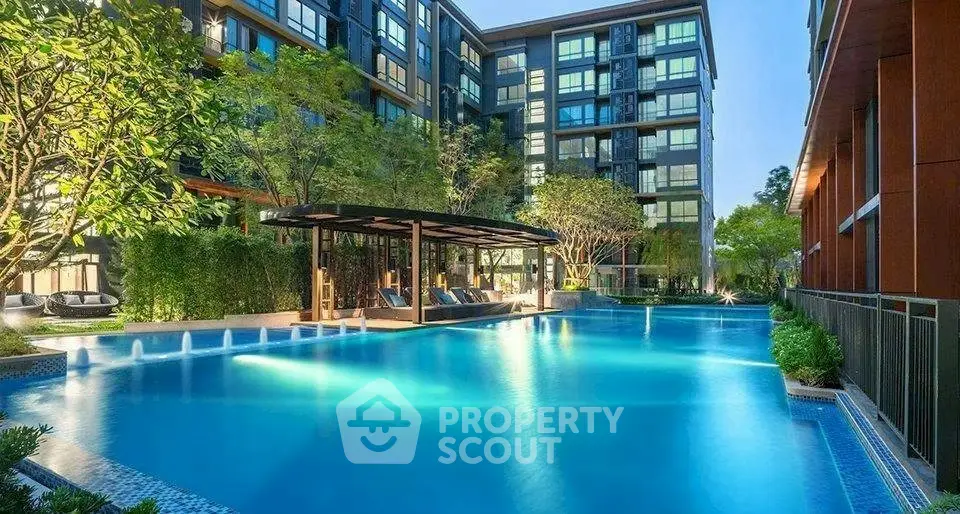 Luxurious apartment complex with stunning pool and lush greenery