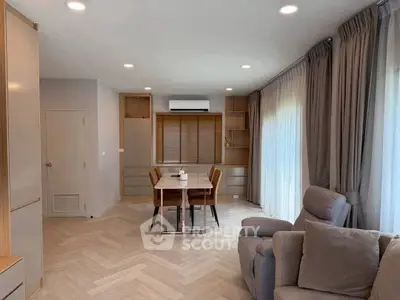 Modern living room with elegant dining area and cozy seating, featuring stylish curtains and ambient lighting.