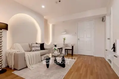 Elegant living room with modern decor and cozy ambiance, featuring stylish furniture and warm lighting.