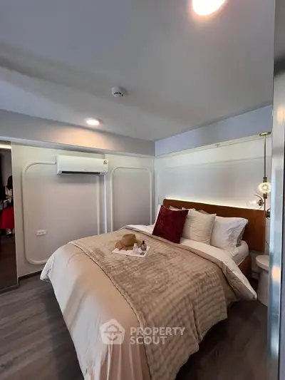 Cozy and stylish bedroom with modern decor and plush bedding, perfect for relaxation.