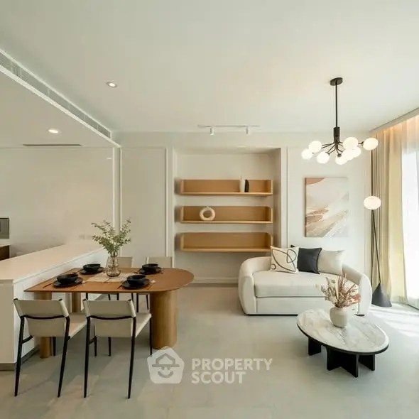 Modern living room with elegant decor and open layout, featuring stylish furniture and natural light.
