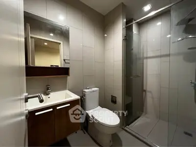 Modern bathroom with sleek fixtures and glass shower enclosure