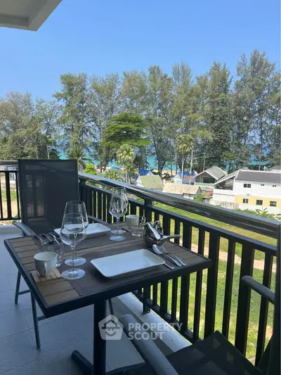 Charming balcony with dining setup and stunning ocean view, perfect for relaxation and outdoor meals.