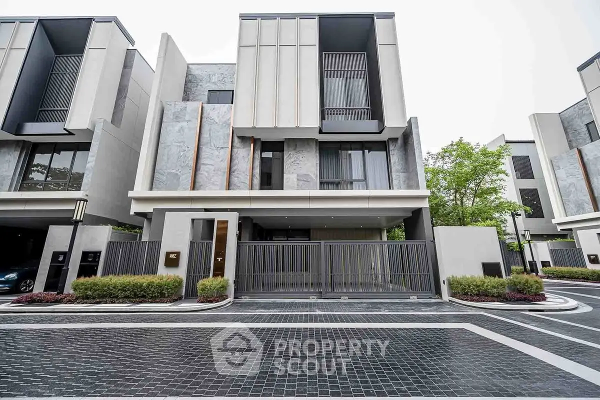 Modern luxury townhouse with sleek design and gated entrance in upscale neighborhood.