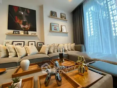 Stylish modern living room with elegant decor and large windows offering city views.