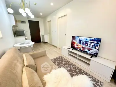 Modern living room with cozy sofa, stylish lighting, and flat-screen TV in a chic apartment.