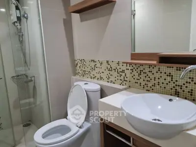 Modern bathroom with sleek fixtures and stylish mosaic tile accents