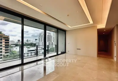 Spacious modern living room with large windows and city view