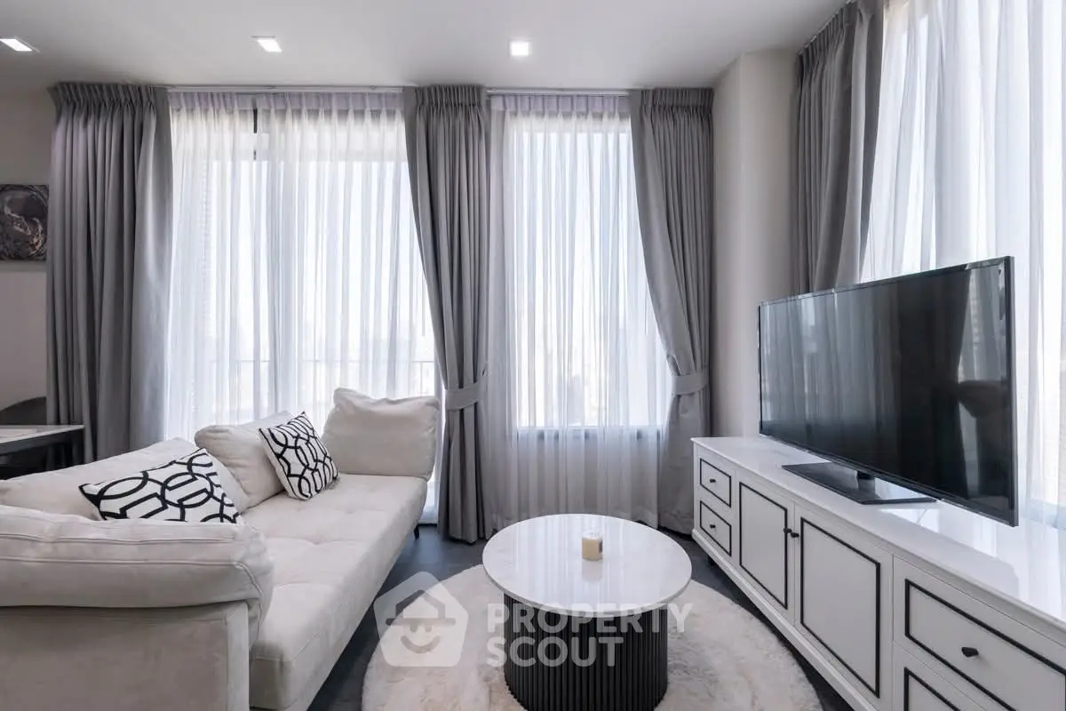 Modern living room with elegant decor and large windows