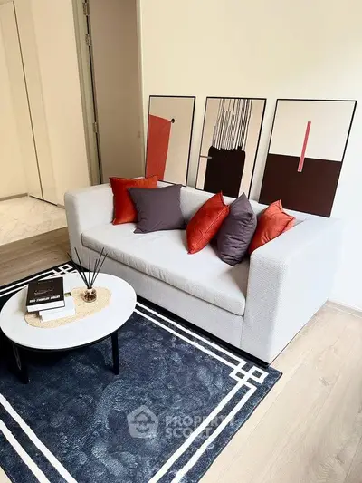 Modern living room with stylish sofa, abstract art, and chic coffee table