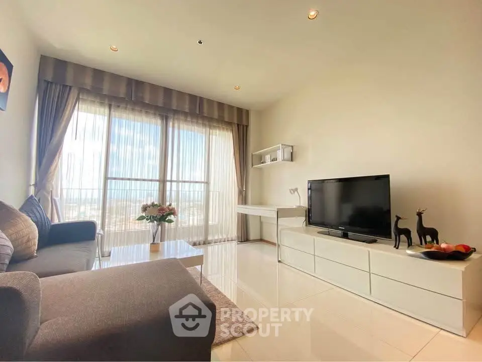 Modern living room with sleek furniture and large windows offering a stunning view.