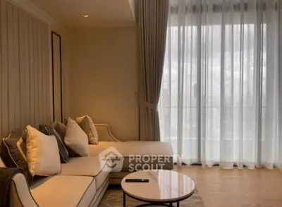 Elegant living room with cozy sofa and sheer curtains