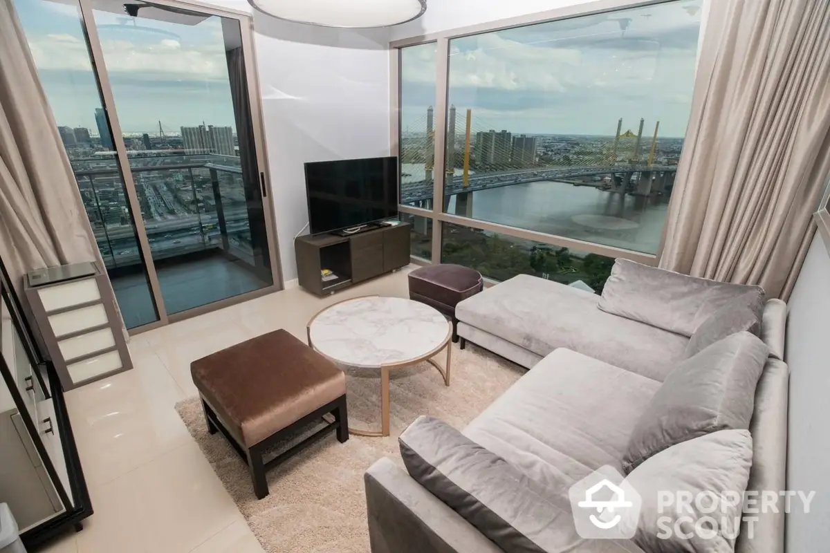 Luxurious corner unit living room with panoramic city and river views, featuring floor-to-ceiling windows and modern furnishings.