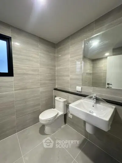 Modern bathroom with sleek gray tiles and contemporary fixtures