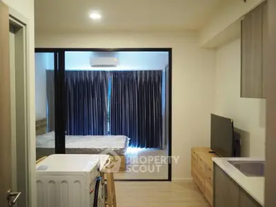 Modern studio apartment with open layout, featuring a cozy bedroom and compact living area.