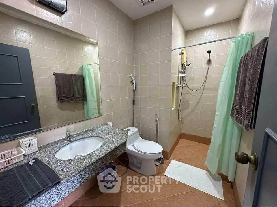 Spacious bathroom with modern fixtures and elegant tile design