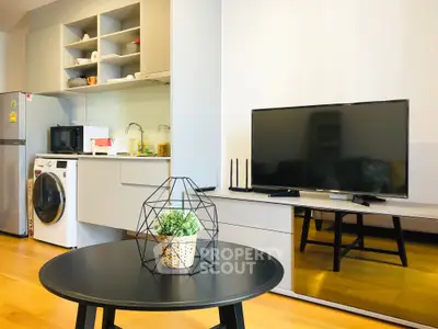 Modern open-layout living room with sleek kitchen and stylish decor