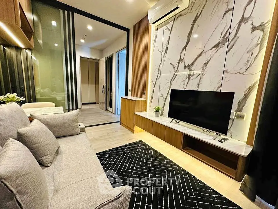 Modern living room with marble accent wall and sleek furniture