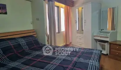 Cozy bedroom with stylish furniture and natural light, perfect for relaxation.