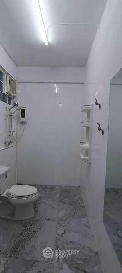 Modern bathroom with sleek white tiles and contemporary fixtures
