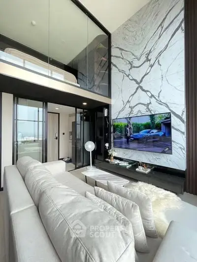 Luxurious modern living room with high ceilings and marble accent wall