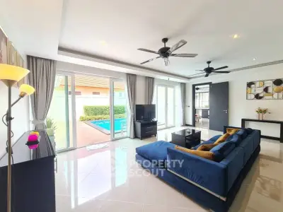 Luxurious living room with pool view, modern decor, and elegant furnishings.