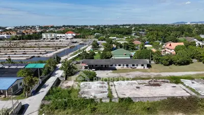 Aerial view of suburban residential area with greenery and spacious plots.