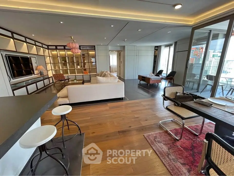 Luxurious open-plan living room with modern decor and city view balcony