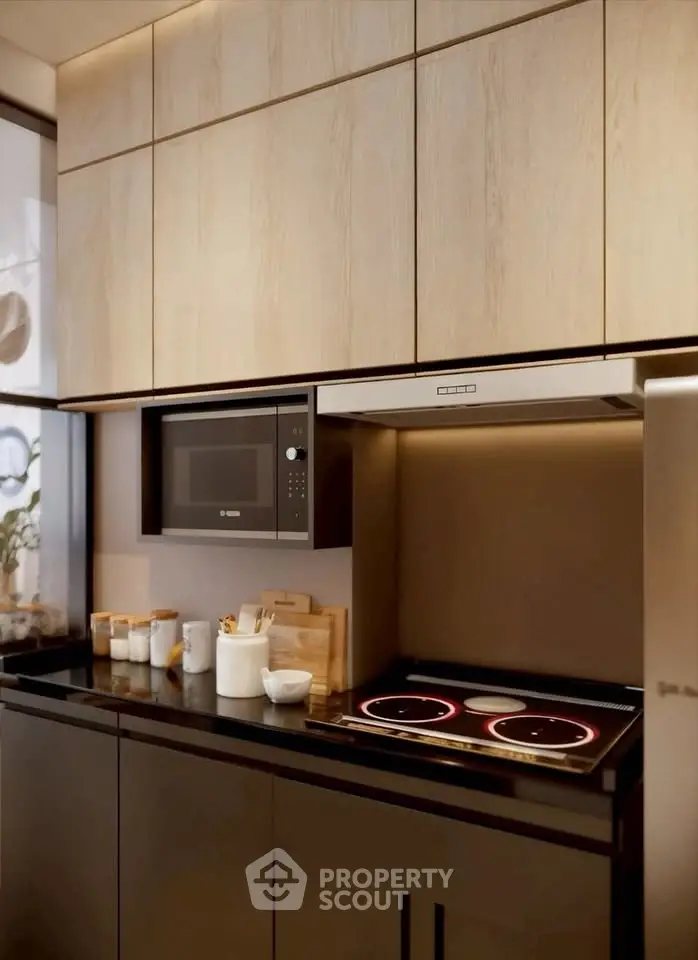 Modern kitchen with sleek cabinets and built-in appliances, featuring an electric stove and microwave.