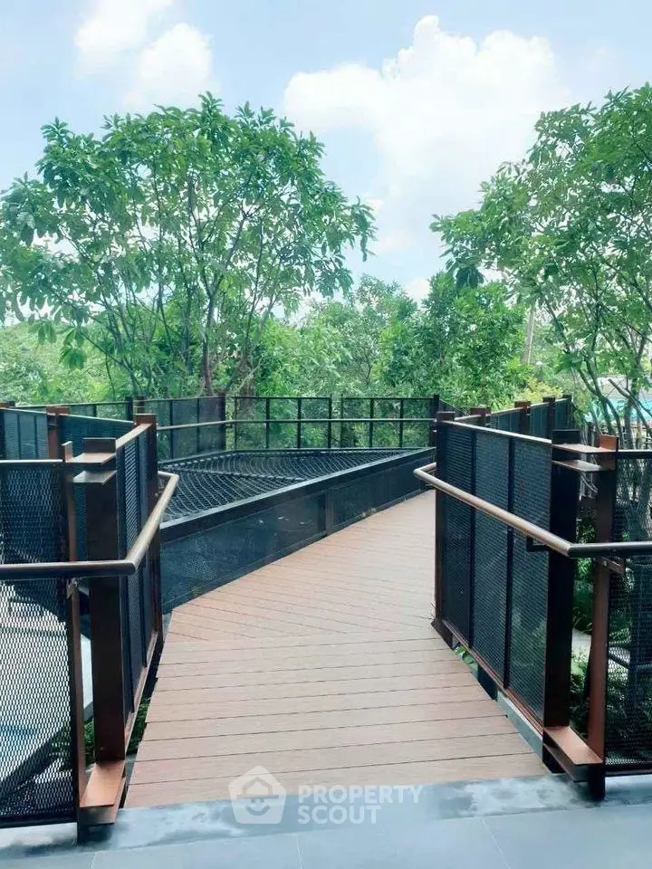 Modern outdoor walkway with lush greenery and sleek railing design.