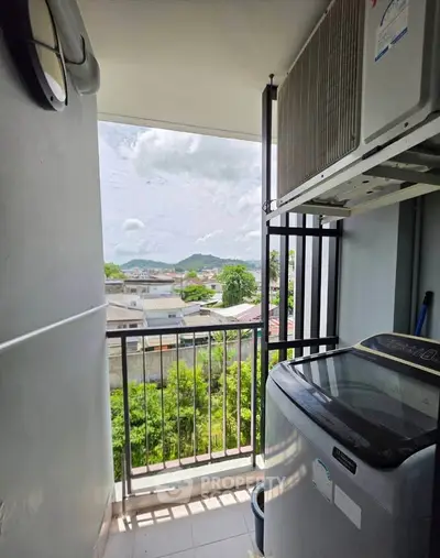 Charming balcony with scenic view and modern washing machine, perfect for urban living.