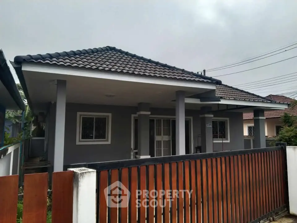 Charming single-story home with modern roof and fenced yard in suburban neighborhood.