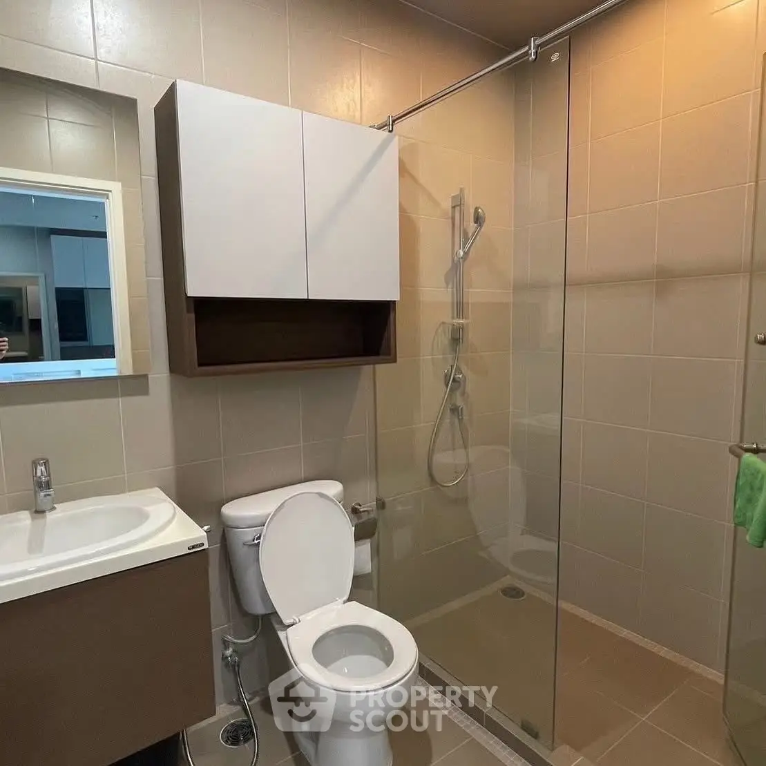 Modern bathroom with glass shower and sleek fixtures