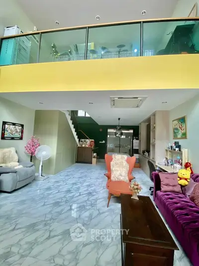 Spacious living room with high ceiling and modern decor in a stylish home