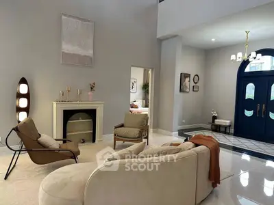 Elegant living room with modern decor and stylish furniture, featuring a cozy fireplace and chic lighting.