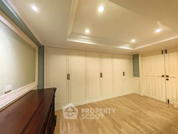 Spacious room with elegant built-in storage and recessed lighting