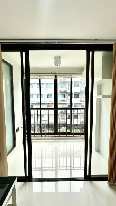Spacious apartment with large balcony and city view, perfect for urban living.