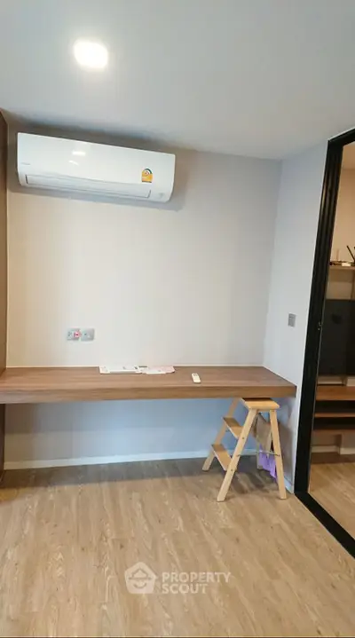 Modern study room with wooden desk and air conditioning unit
