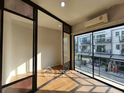 Modern living room with large windows and natural light in urban townhouse