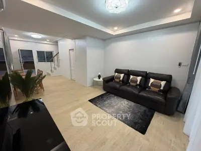 Spacious modern living room with elegant decor and open dining area, perfect for family gatherings.